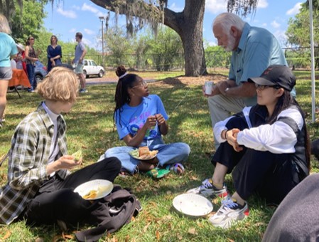 students eating lunch on a lawn