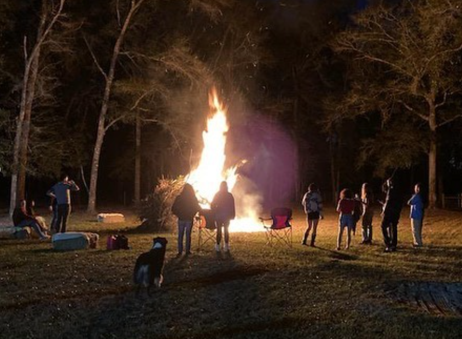 students standing around a bonfire
