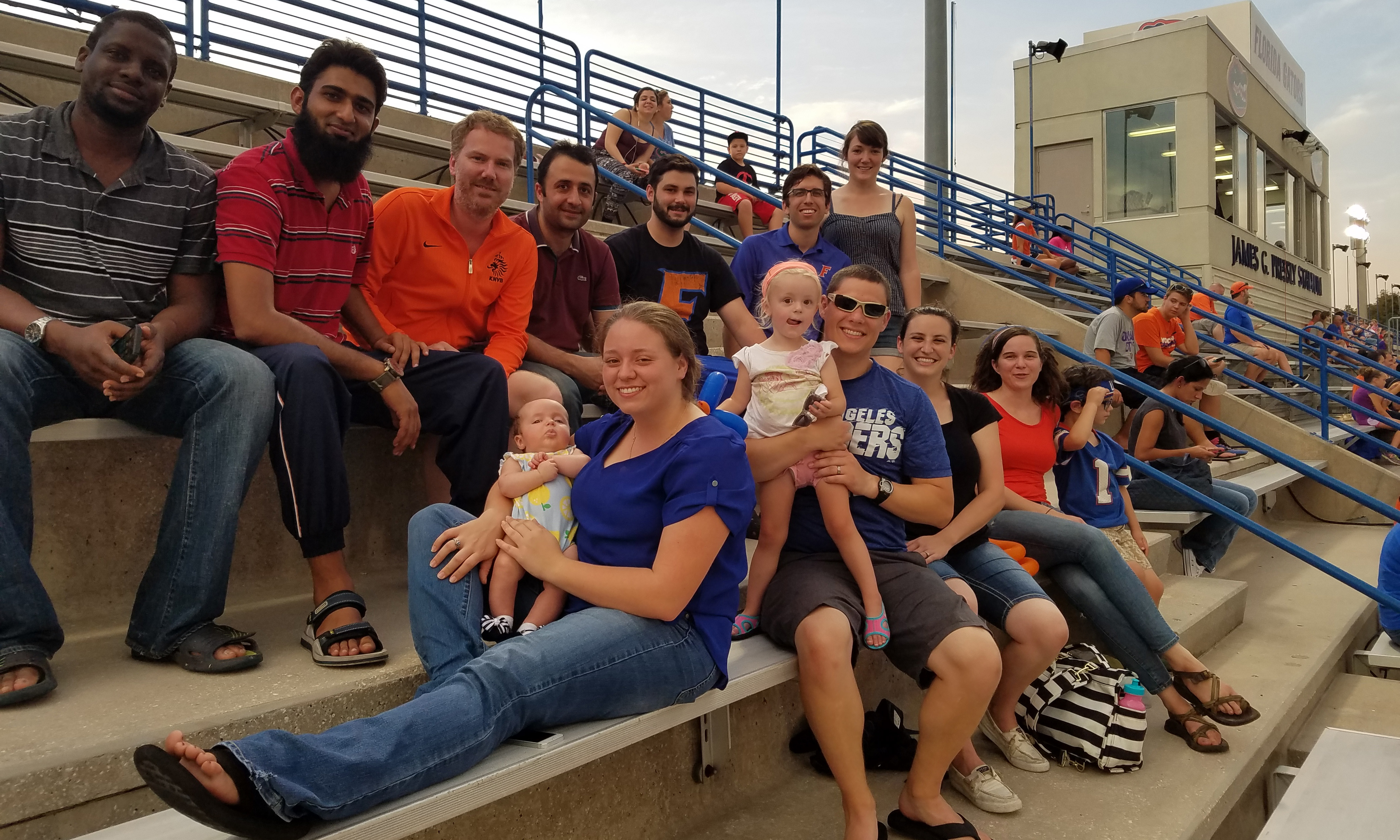 The honey bee lab members sitting on bleachers at a UF gator game