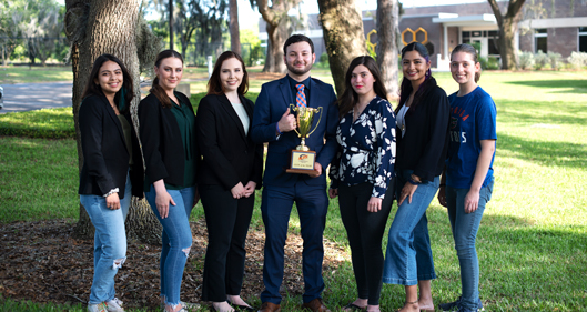 Entomology Club standing with their trophy