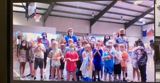 Jennifer Standley with students in a gym.