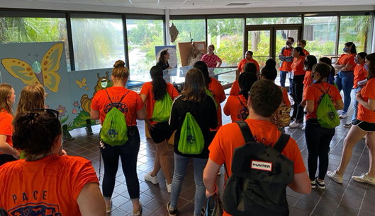 Students in the hallway in orange tshirts.