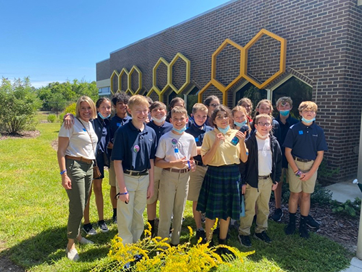 Ambleside 7th Grade students in front of the honey bee lab during their departmental tour
