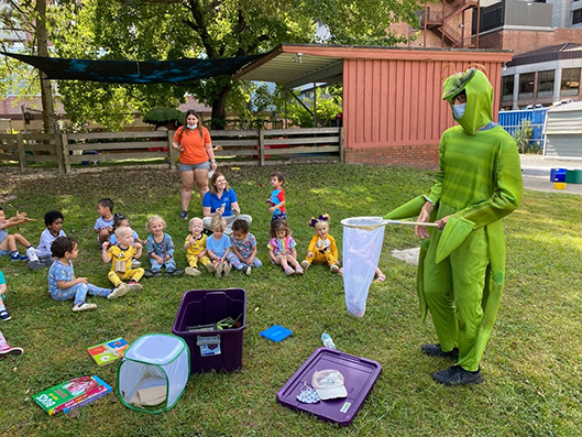 Joshua-Botti Anderson pictured in the mantis costume showing the two year old Baby Gators how to collects insects